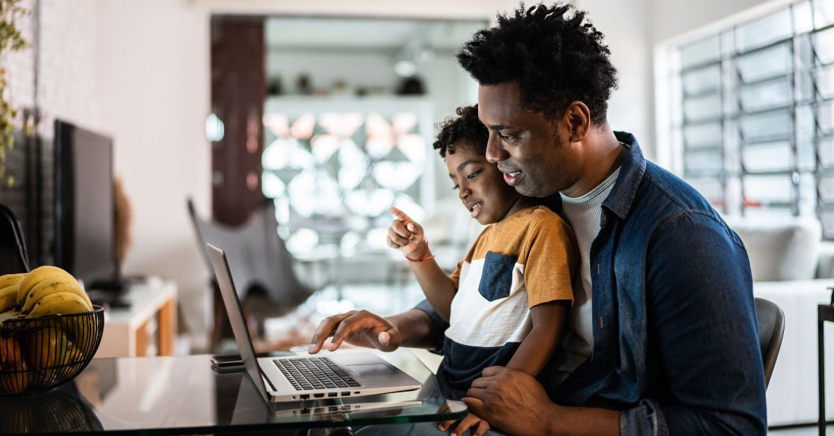 Father and son looking at computer