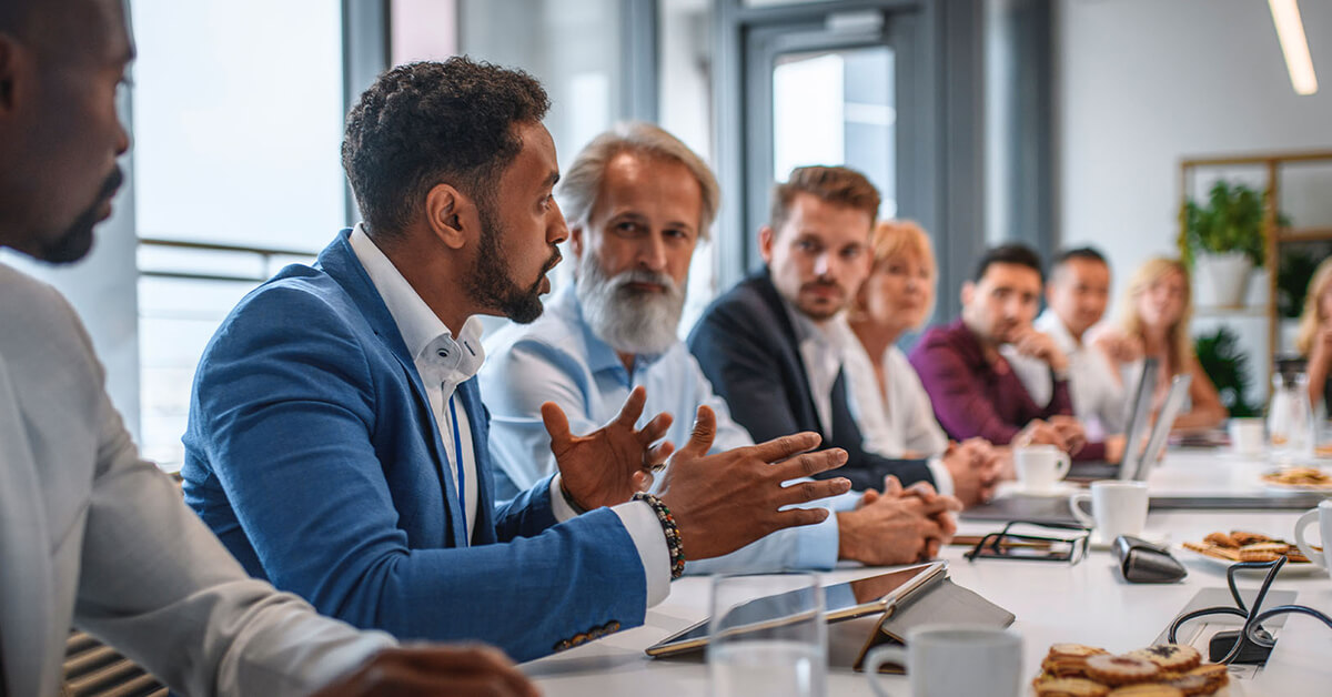 men sitting at conference room table