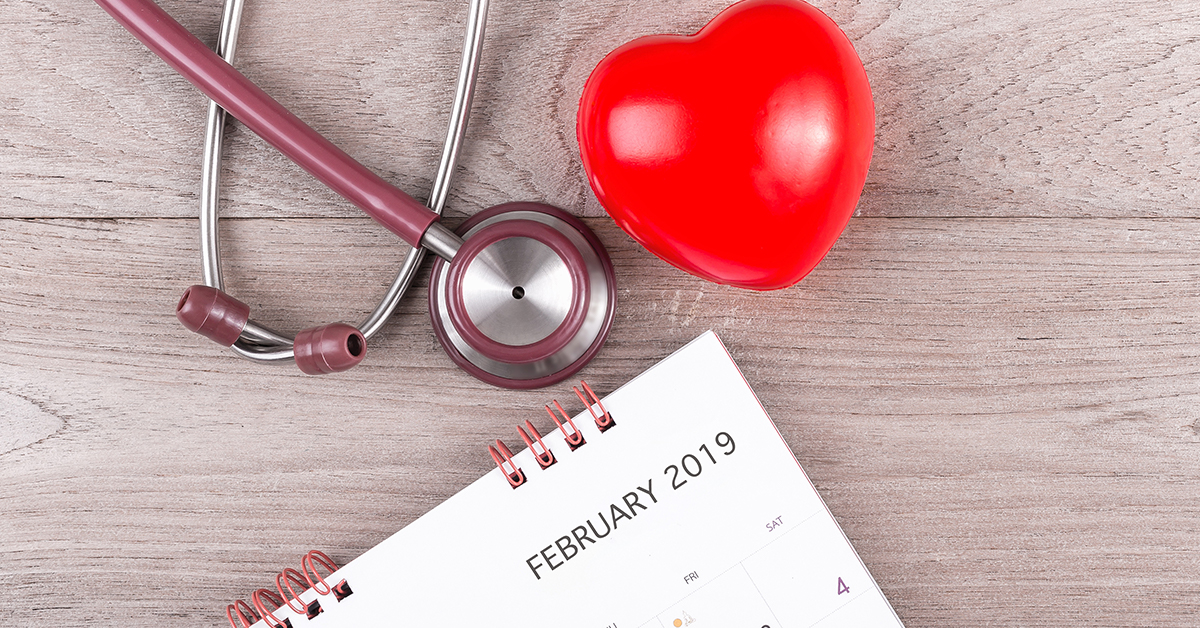 decorative heart and stethoscope on desk next to calendar