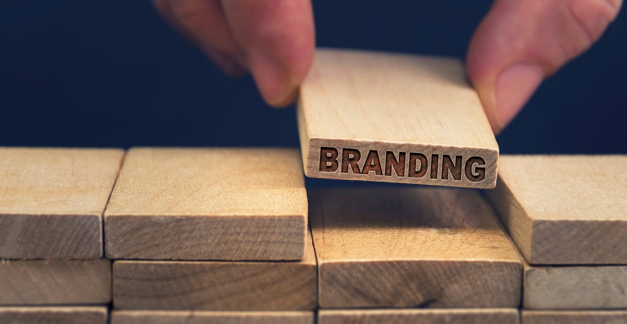 Wooden blocks being stacked with one block labeled 'branding'